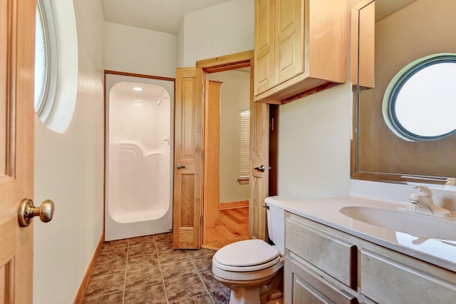 bathroom with tile floors, toilet, and oversized vanity