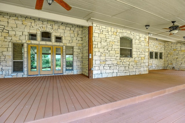 deck with french doors and ceiling fan