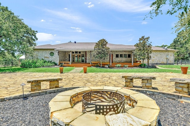 view of terrace featuring an outdoor fire pit and french doors