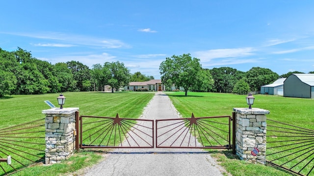 view of gate featuring a lawn