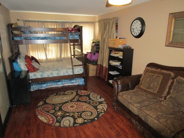 living room with a barn door, ceiling fan, wood-type flooring, and french doors