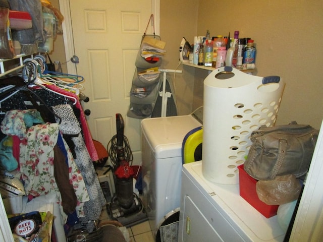 washroom with washer and dryer and light tile floors