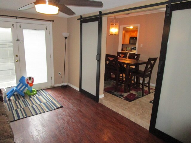 kitchen with light tile flooring, sink, and black appliances