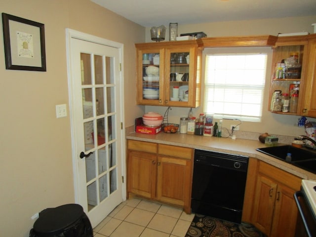 kitchen with light tile floors, range, dishwasher, and sink