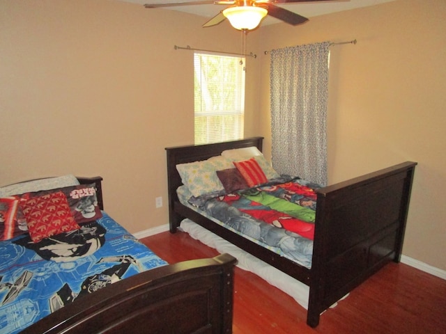 bedroom featuring ceiling fan and dark hardwood / wood-style flooring