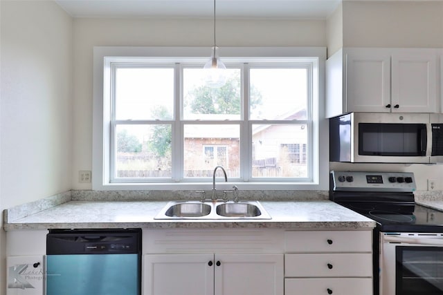 kitchen with pendant lighting, white cabinetry, appliances with stainless steel finishes, and sink