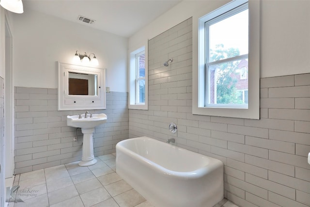 bathroom featuring tile walls and tile flooring