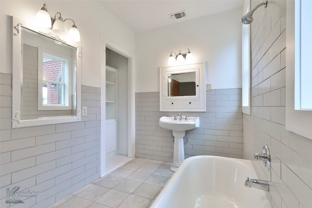 bathroom featuring tile walls and tile flooring