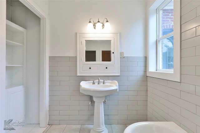 bathroom with tile walls and tile flooring