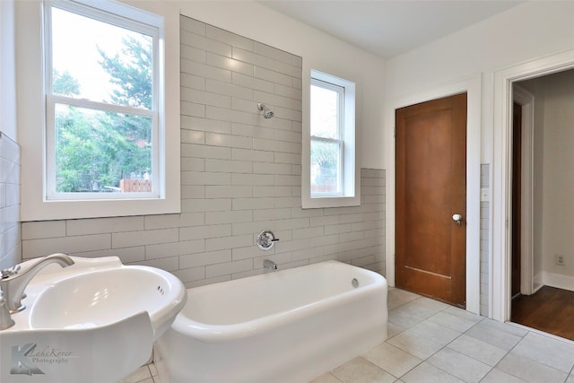 bathroom featuring tile walls, sink, and tile flooring