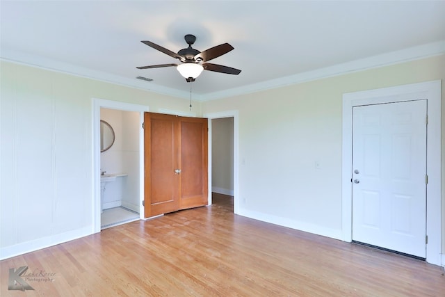 unfurnished bedroom with connected bathroom, ornamental molding, ceiling fan, and light wood-type flooring