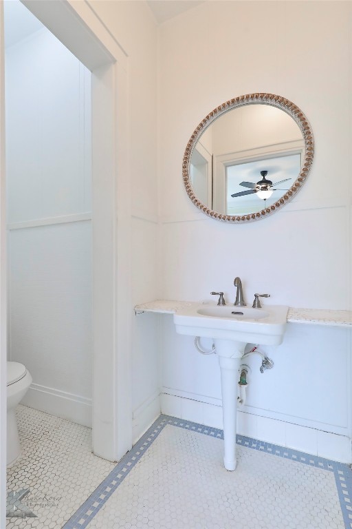 bathroom with toilet, tile floors, and ceiling fan