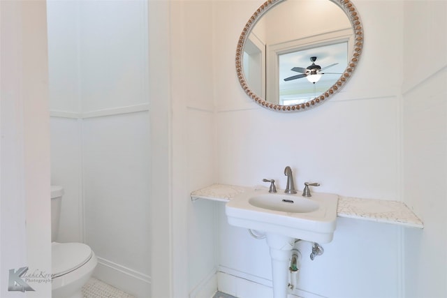 bathroom with toilet, tile floors, and ceiling fan