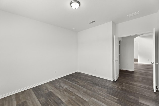 empty room with dark hardwood / wood-style floors