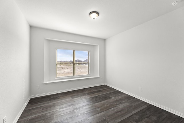 spare room featuring dark wood-type flooring