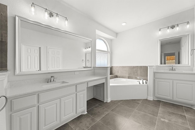 bathroom with vanity, tile floors, and a bathtub