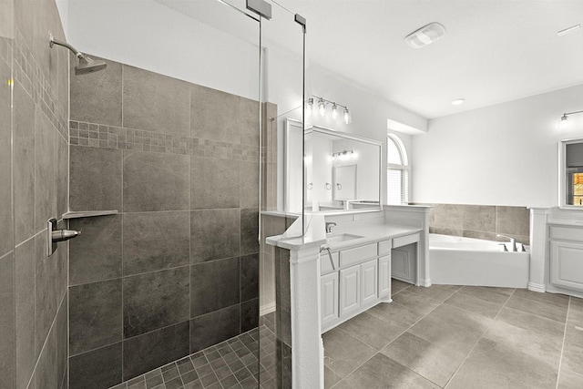 bathroom featuring plus walk in shower, oversized vanity, and tile floors