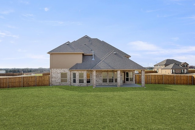 back of property with a patio area and a yard