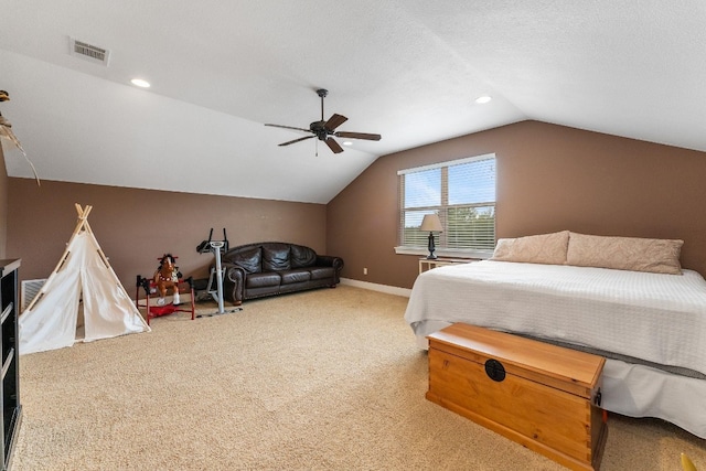 carpeted bedroom featuring lofted ceiling, ceiling fan, and a textured ceiling