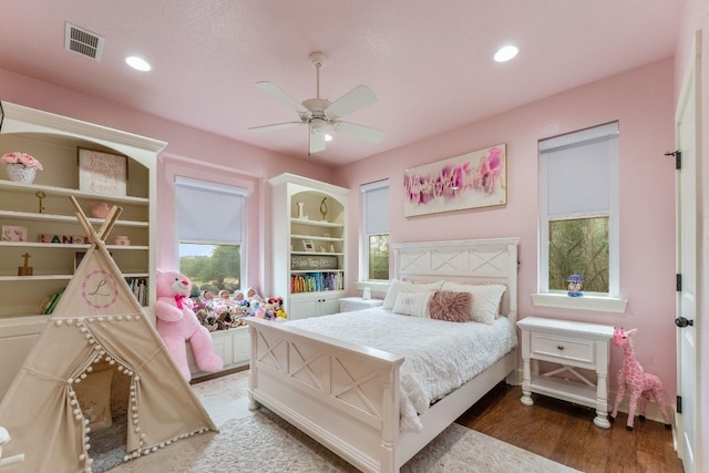 bedroom featuring ceiling fan and dark wood-type flooring