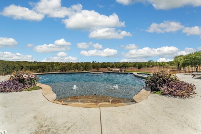 view of pool featuring a patio area, pool water feature, and a hot tub