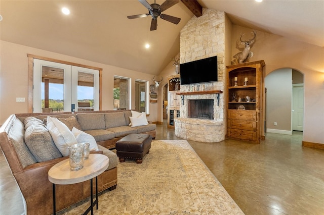 living room with beam ceiling, ceiling fan, high vaulted ceiling, and a fireplace