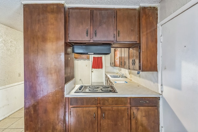 kitchen with range hood, a textured ceiling, sink, and stainless steel gas cooktop