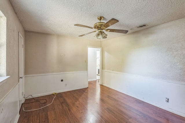 spare room featuring hardwood / wood-style flooring, ceiling fan, and a textured ceiling