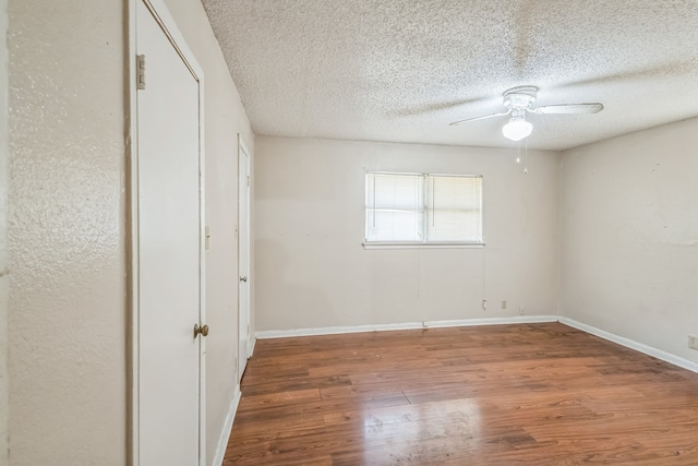 unfurnished bedroom with ceiling fan, wood-type flooring, and a textured ceiling