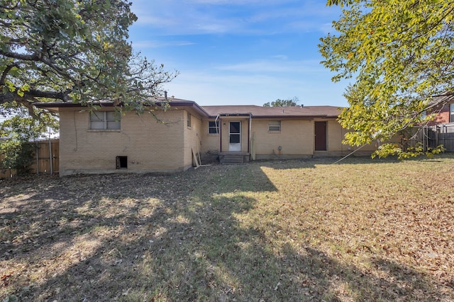 rear view of property featuring a yard