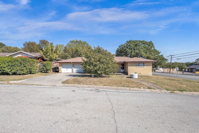 view of front of property with a front yard and a garage