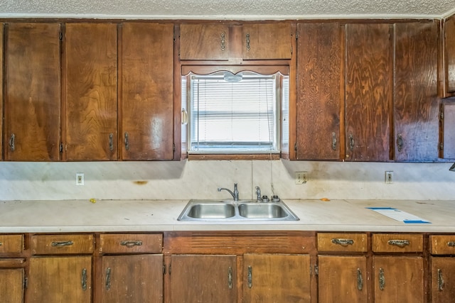 kitchen featuring tasteful backsplash and sink