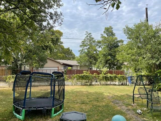 view of yard with a trampoline