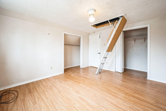 unfurnished bedroom featuring a textured ceiling and light wood-type flooring