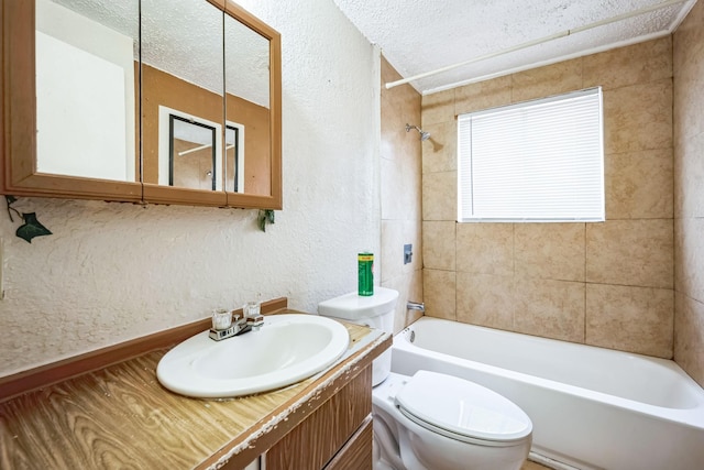 full bathroom featuring toilet, tiled shower / bath, a textured ceiling, vanity, and a wealth of natural light