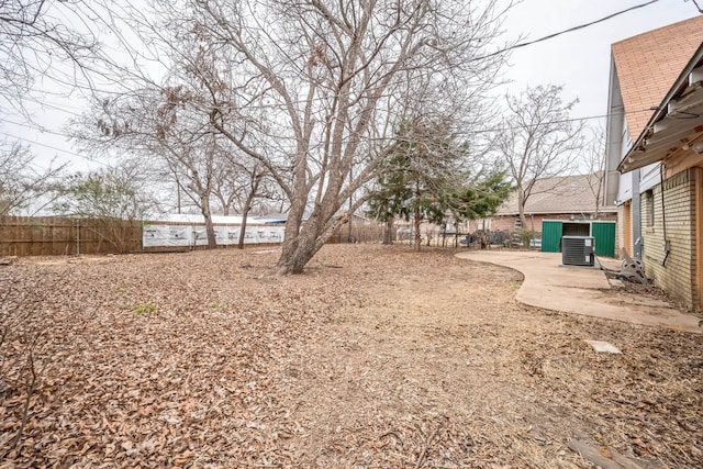 view of yard with a patio and central air condition unit