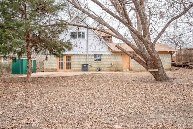 rear view of house with a patio, central AC, and french doors