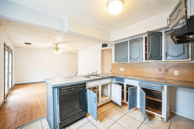 kitchen with light tile patterned floors, dishwasher, ceiling fan, a textured ceiling, and kitchen peninsula