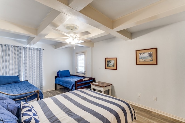 bedroom with dark hardwood / wood-style flooring, ceiling fan, coffered ceiling, and beamed ceiling