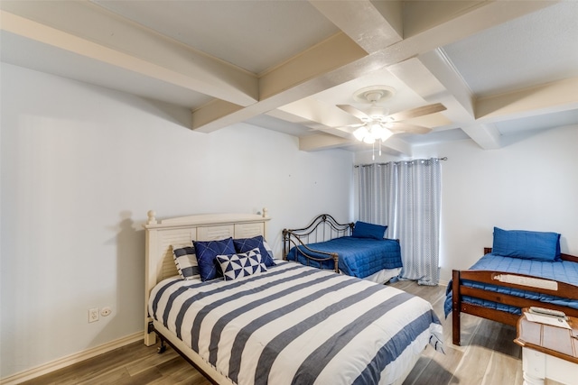 bedroom with ceiling fan, coffered ceiling, dark wood-type flooring, and beamed ceiling