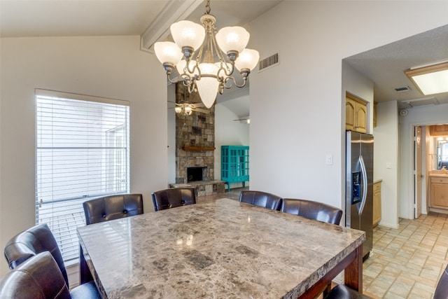 tiled dining space featuring a notable chandelier, a stone fireplace, and vaulted ceiling with beams