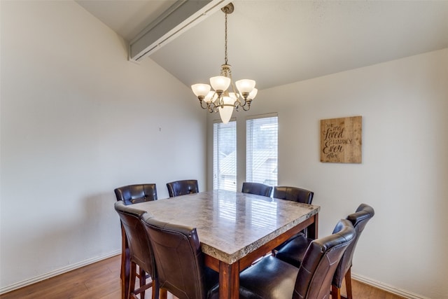 dining room featuring dark hardwood / wood-style flooring, a notable chandelier, and lofted ceiling with beams