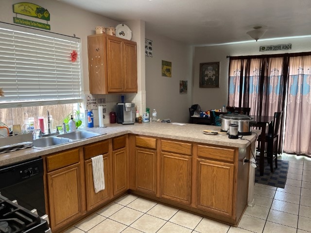 kitchen featuring sink, kitchen peninsula, light tile floors, and black dishwasher