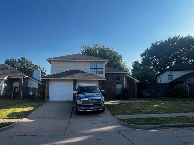 view of front of home with a front lawn and a garage