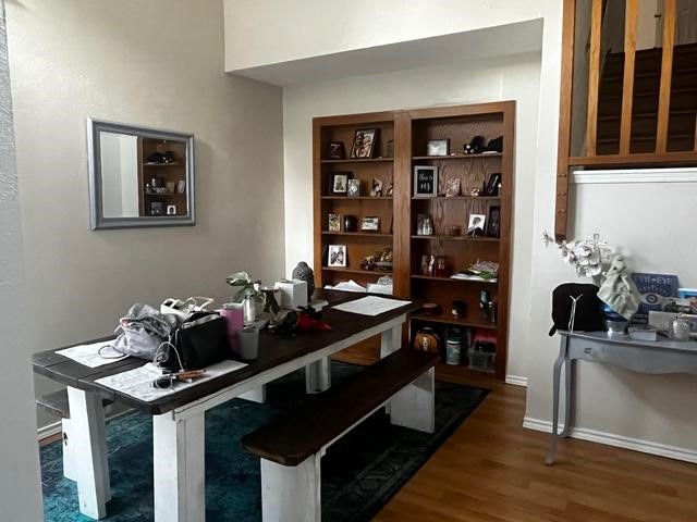 dining area featuring dark hardwood / wood-style floors and built in shelves