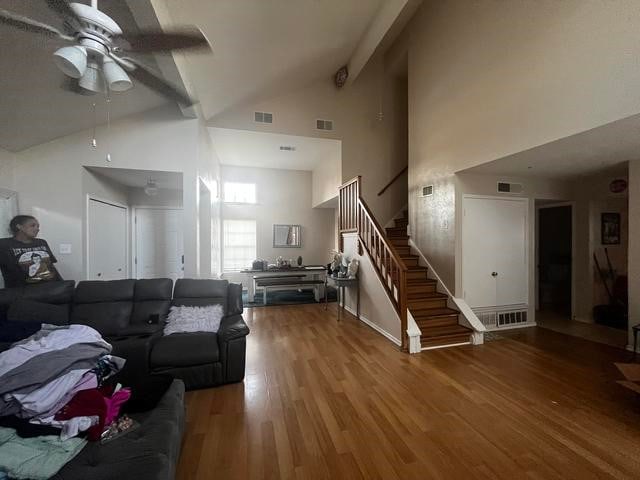 living room with beam ceiling, high vaulted ceiling, wood-type flooring, and ceiling fan