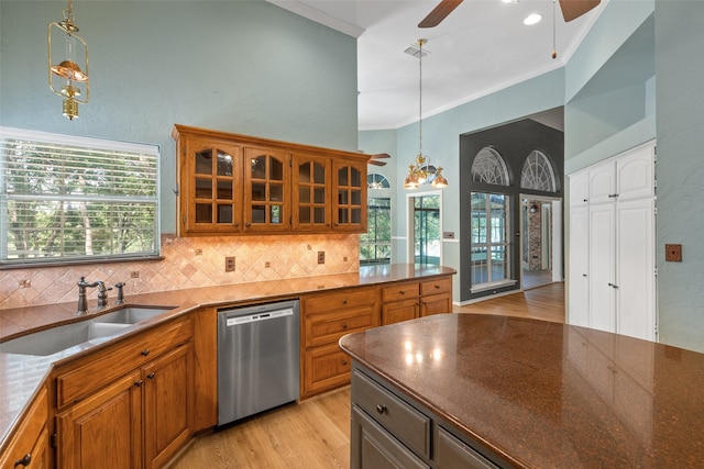 kitchen with sink, dishwasher, ceiling fan with notable chandelier, light hardwood / wood-style floors, and pendant lighting