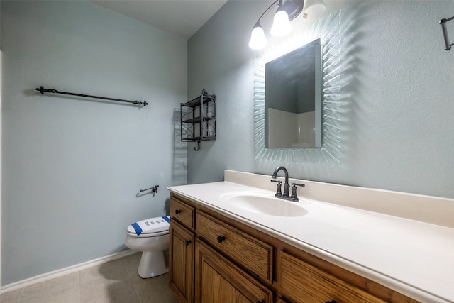 bathroom featuring vanity, toilet, and tile flooring