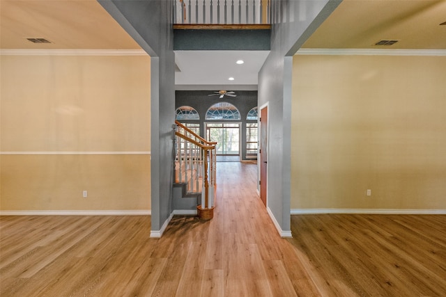 hall with wood-type flooring and crown molding