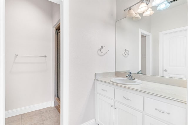 bathroom featuring tile patterned flooring, an enclosed shower, and vanity